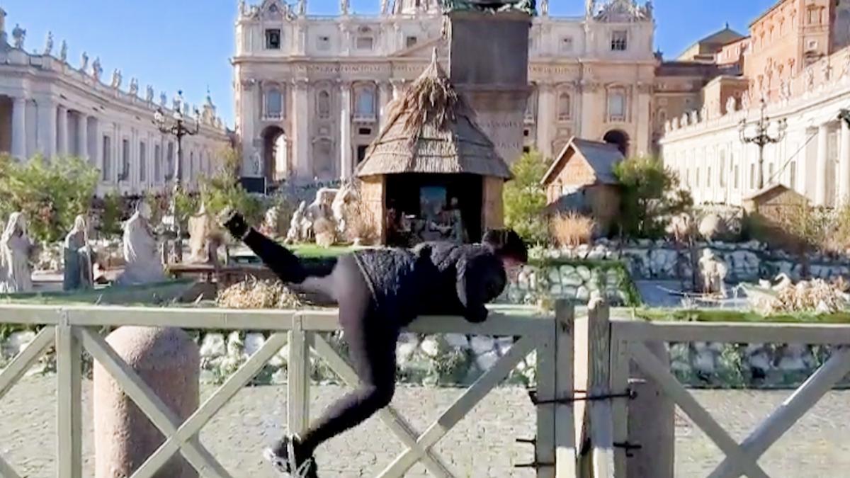 A Femen activist tries to take the Baby Jesus from the Vatican Nativity Scene