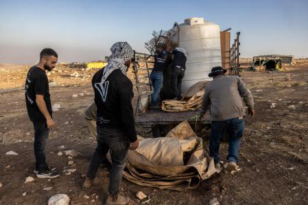 Palestinian men dismantle their houses in Ramallah
