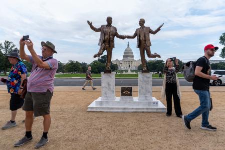 Citizens take photos with the statue, which has bothered the White House.